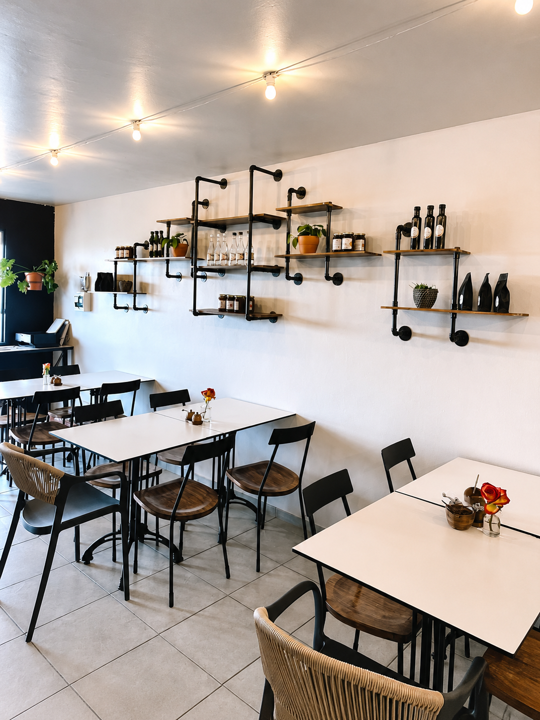Interior of Nicci's Coffee Club with pipe shelving and cream walls